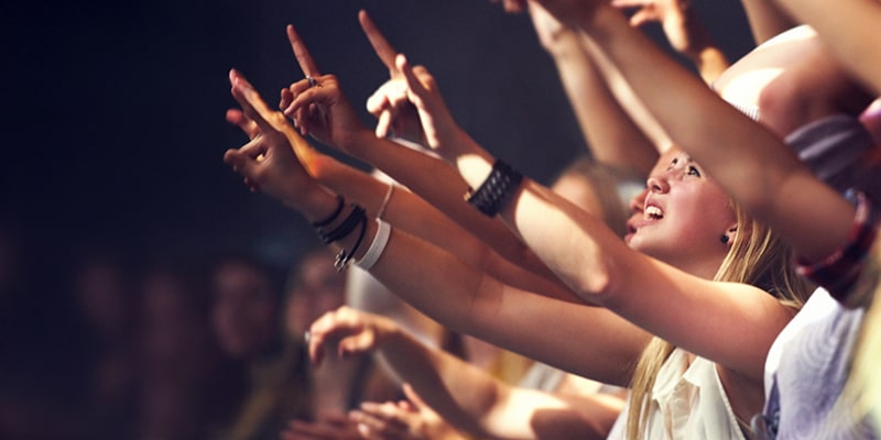 crowd raising hands at ignite youth conference