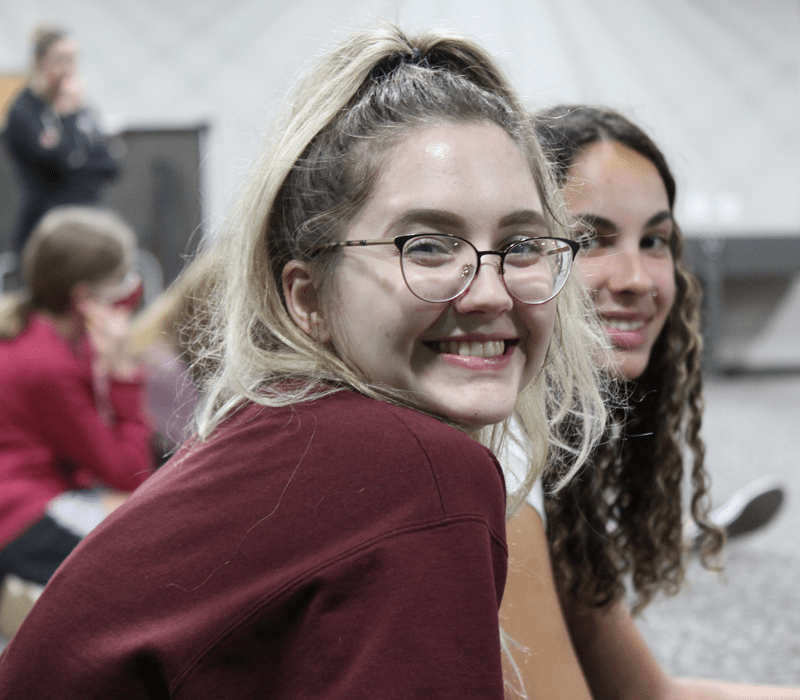 girl friends smiling while learning at church youth group