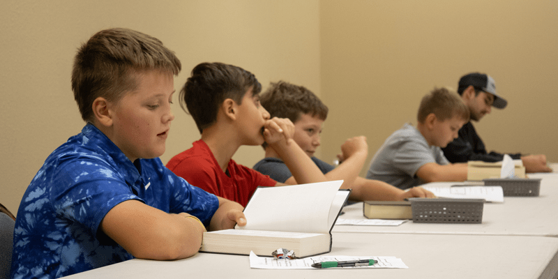 middle school youth boys reading the bible at youth group